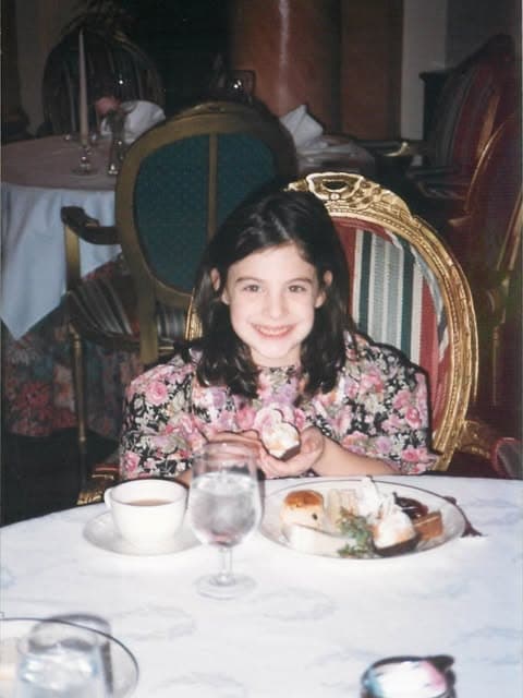 Sophie as a young girl at a dinner table at The Adolphus in Dallas