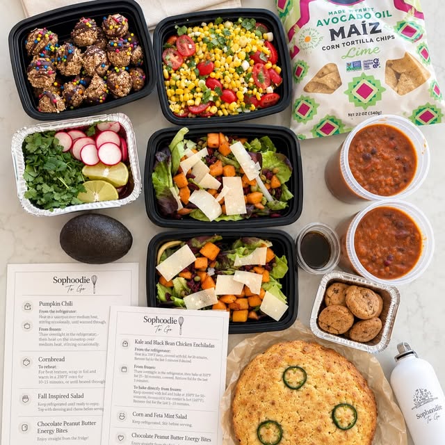 A packed Sophoodie delivery: pumpkin chili, cornbread and butternut squash salad in their containers, with the printed menu card