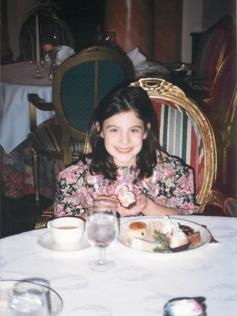 Sophie as a young girl at a dinner table at The Adolphus in Dallas